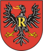 A black eagle on a red background with the letter R on its chest, symbolizing the first letter of the country.