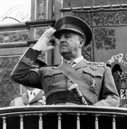 A black-and-white photograph of Romero I in mid-20th century military uniform saluting